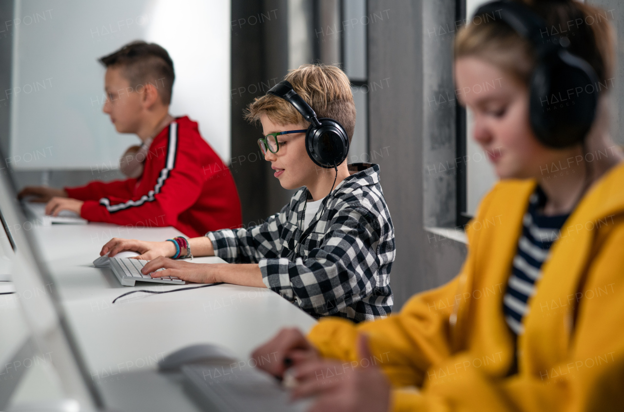 School kids using computer in a classroom at school