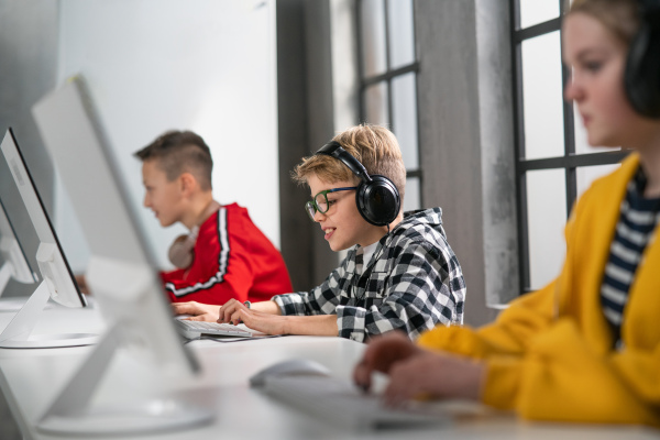 School kids using computer in a classroom at school