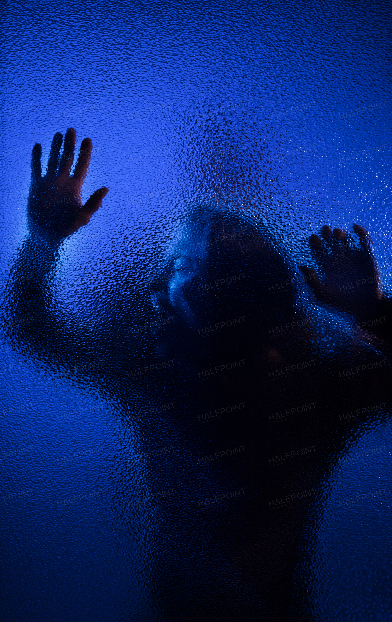 The shadow of woman screaming behind the glass, domestic violence concept.