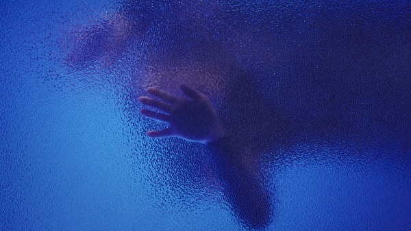 A vertical footage of shadow of woman screaming behind the glass, domestic violence concept.