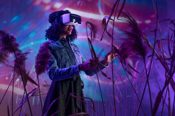 Metaverse digital cyber world technology, girl with virtual reality VR goggles playing augmented reality game, futuristic lifestyle