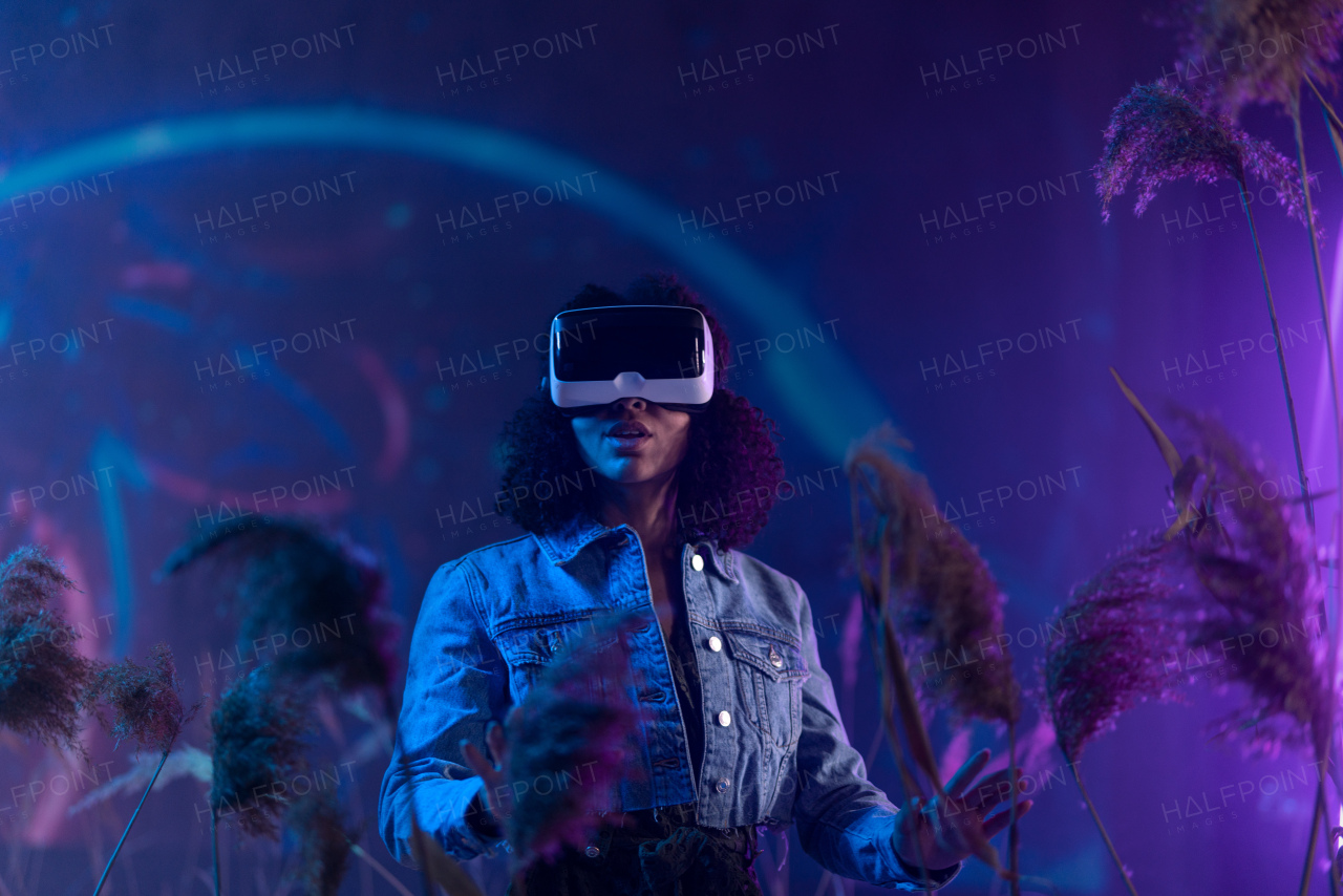 Metaverse digital cyber world technology, girl with virtual reality VR goggles playing augmented reality game, futuristic lifestyle