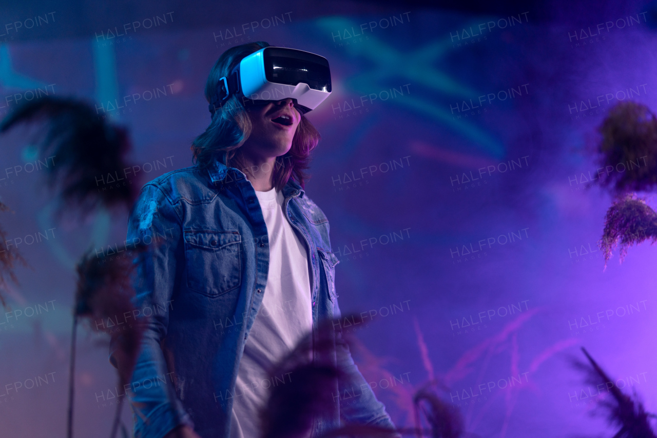 Metaverse digital cyber world technology, a man with virtual reality VR goggles playing augmented reality game, futuristic lifestyle