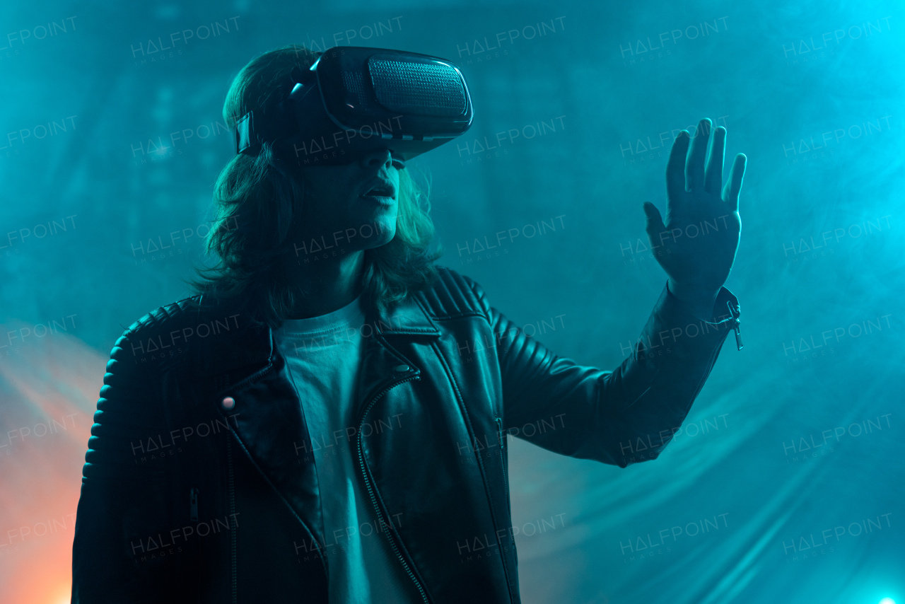 Metaverse digital cyber world technology, a man with virtual reality VR goggles playing augmented reality game, futuristic lifestyle