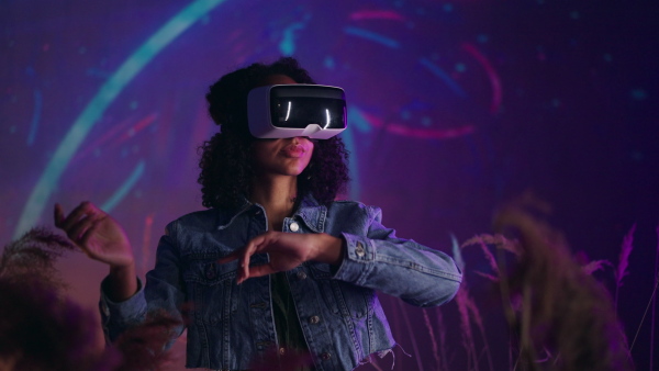 Metaverse digital cyber world technology, girl with virtual reality VR goggles playing augmented reality game, futuristic lifestyle