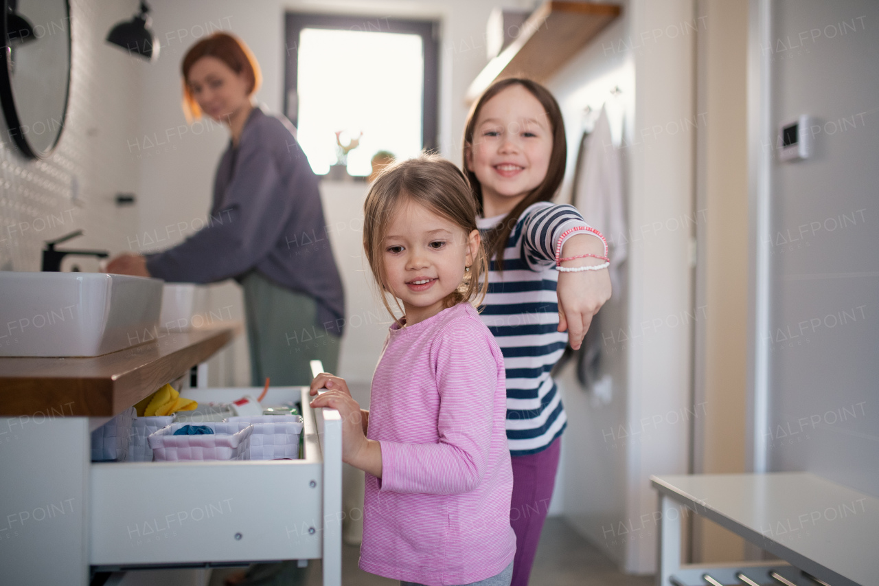 A mother with little children in bathroom, morning routine concept.