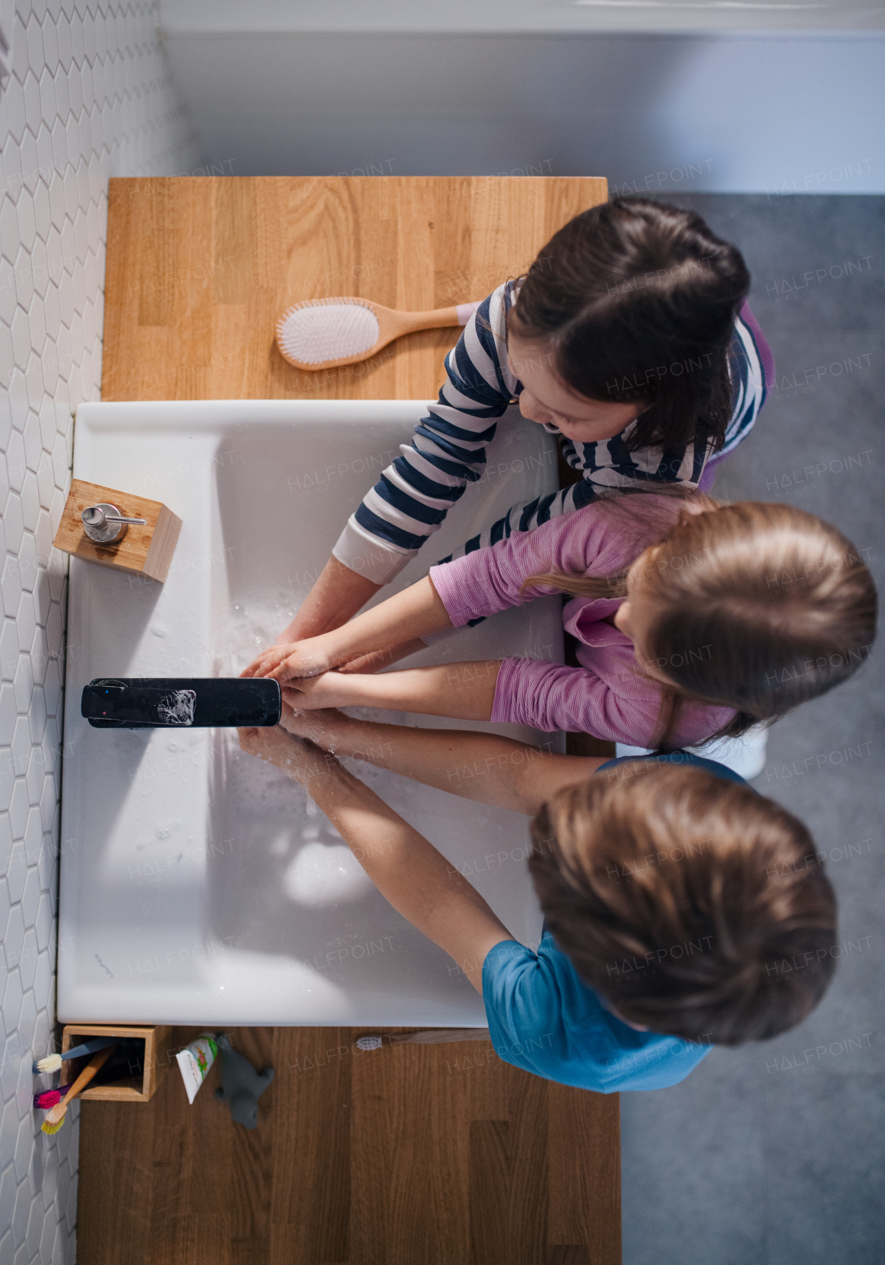 A top view of little children in bathroom, washing hands.