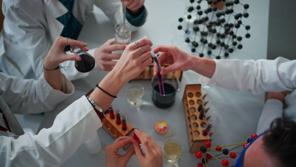 Science students doing a chemical experiment in the laboratory at university.