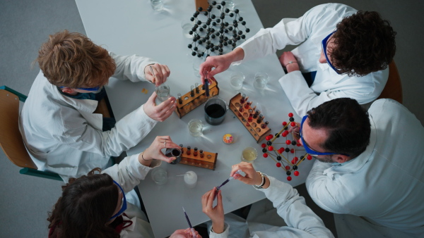 Science students doing a chemical experiment in the laboratory at university.