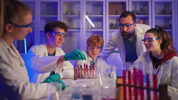 Science students doing a chemical experiment in the laboratory at university.