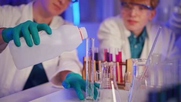 Science students doing a chemical experiment in the laboratory at university.