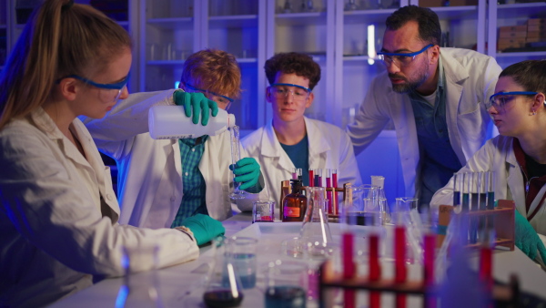 Science students doing a chemical experiment in the laboratory at university.