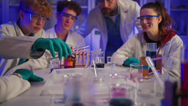 Science students doing a chemical experiment in the laboratory at university.