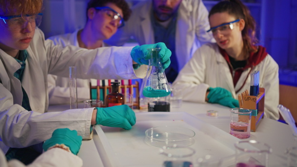 Science students doing a chemical experiment in the laboratory at university.