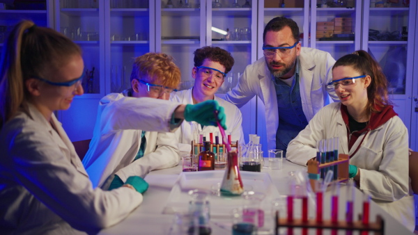 Science students doing a chemical experiment in the laboratory at university.