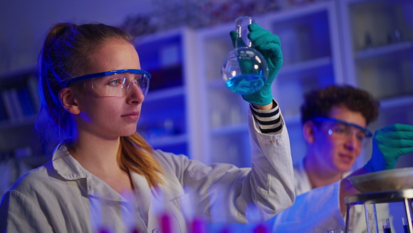 Science students doing a chemical experiment in the laboratory at university.