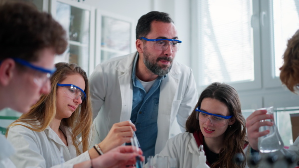 Science students doing a chemical experiment in the laboratory at university.