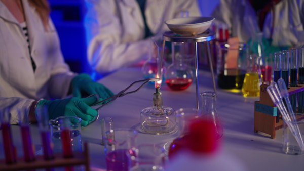 Excited science students doing a chemical experiment in the laboratory at university.