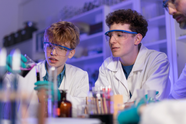 Science students doing a chemical experiment in the laboratory at university.