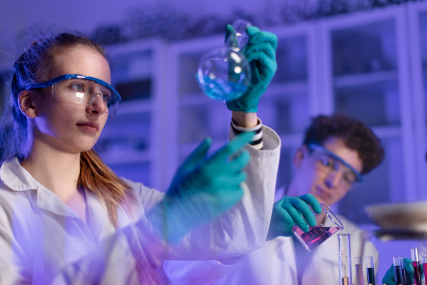 A science student doing chemical experiment in the laboratory at university.