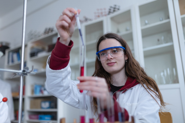 Science students doing a chemical experiment in the laboratory at university.