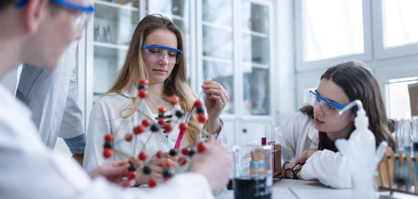 Science students doing a chemical experiment in the laboratory at university.