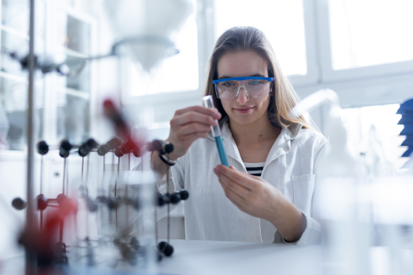 Science students doing a chemical experiment in the laboratory at university.