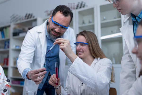 Science students doing a chemical experiment in the laboratory at university.