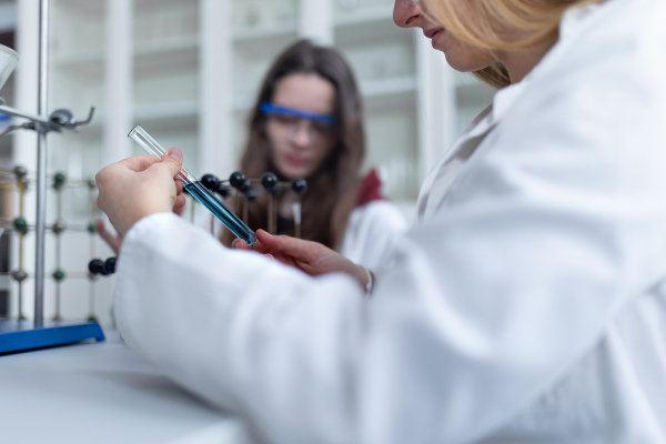 Science students doing a chemical experiment in the laboratory at university. Women in science concept.