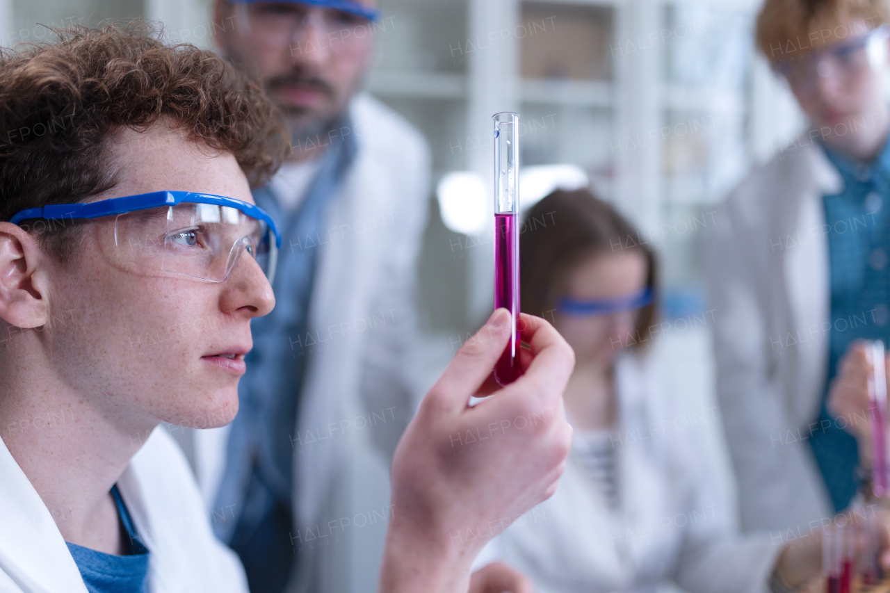 Science students doing a chemical experiment in the laboratory at university.