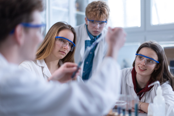 Science students doing a chemical experiment in the laboratory at university.