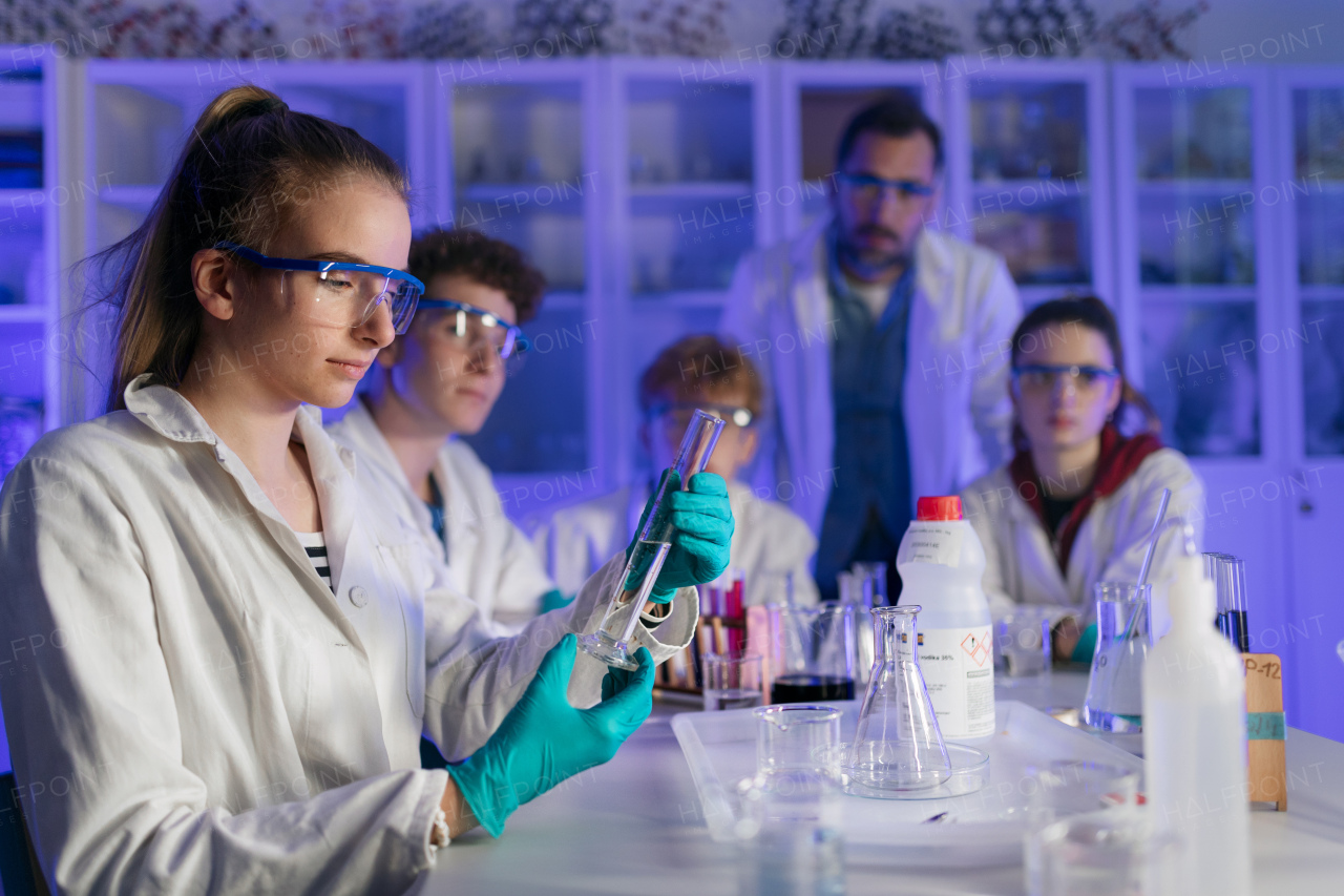 Science students doing a chemical experiment in the laboratory at university.