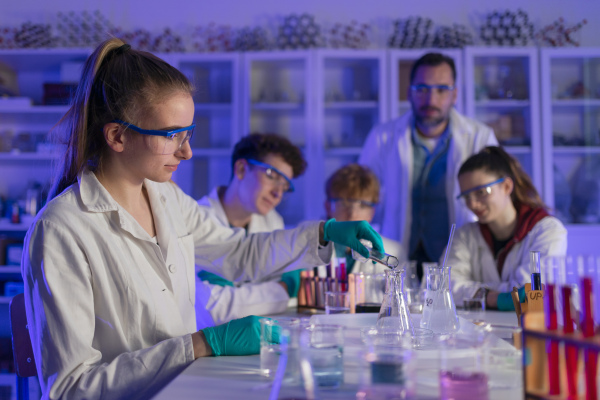 Science students doing a chemical experiment in the laboratory at university.