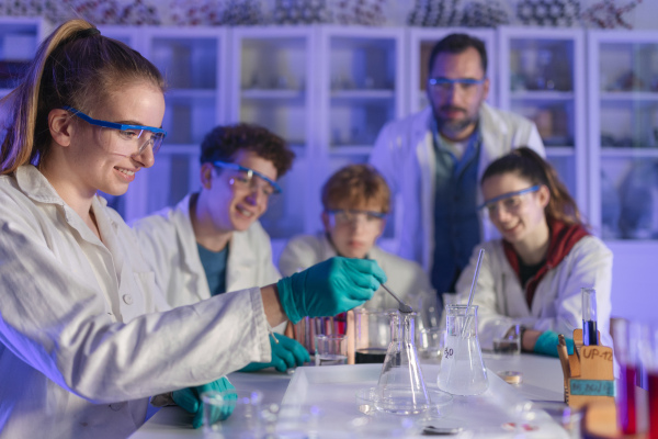 Science students doing a chemical experiment in the laboratory at university.