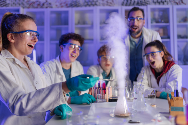 Science students doing a chemical experiment in the laboratory at university.