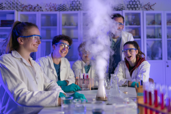 Science students doing a chemical experiment in the laboratory at university.