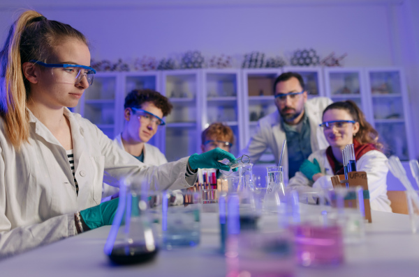 Science students doing a chemical experiment in the laboratory at university.