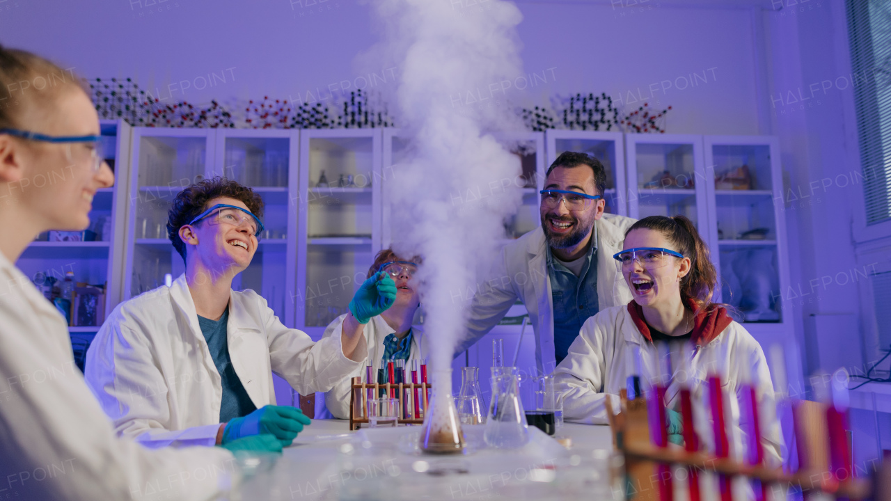 Science students doing a chemical experiment in the laboratory at university.