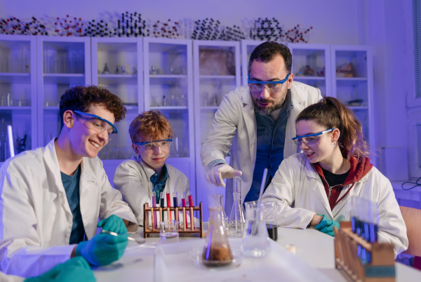 Science students doing a chemical experiment in the laboratory at university.