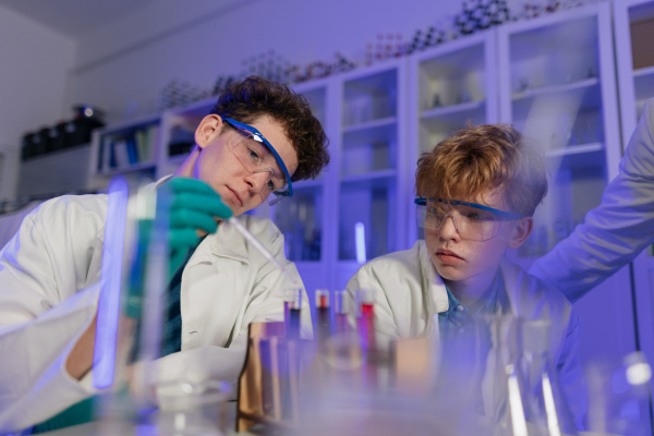 A science student doing chemical experiment in the laboratory at university.