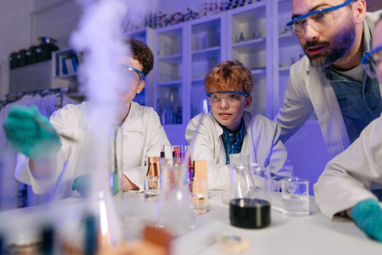 Science students doing a chemical experiment in the laboratory at university.