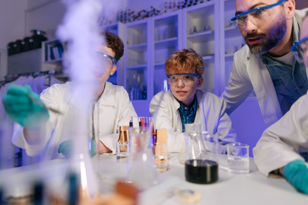 Science students doing a chemical experiment in the laboratory at university.