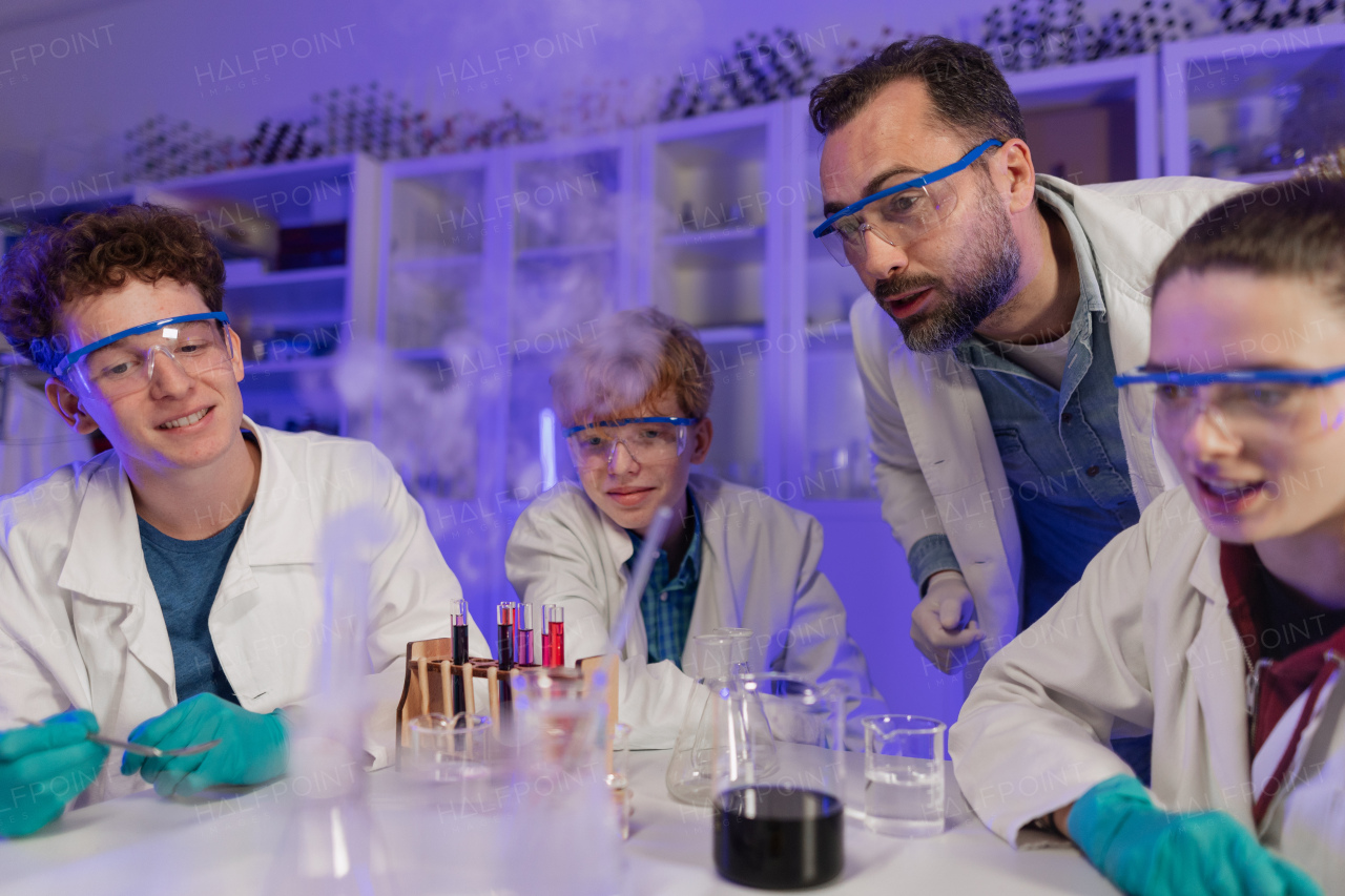 Science students doing a chemical experiment in the laboratory at university.