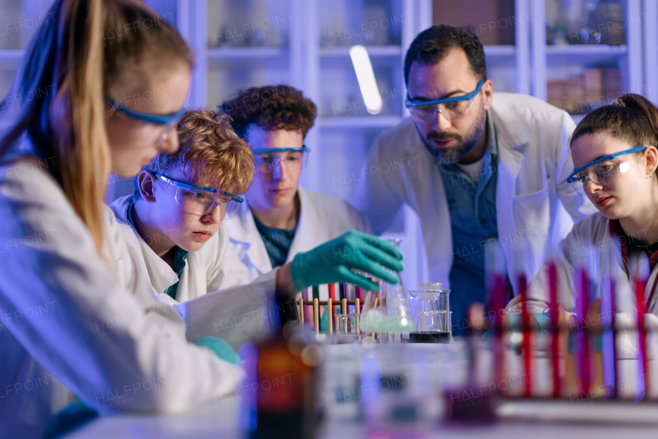 Science students doing a chemical experiment in the laboratory at university.