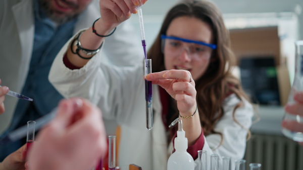 Science students doing a chemical experiment in the laboratory at university.