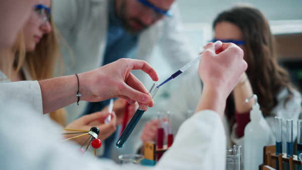 Science students doing a chemical experiment in the laboratory at university.