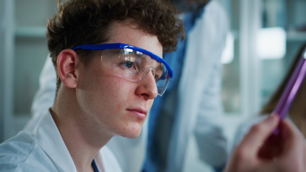 Science students doing a chemical experiment in the laboratory at university.