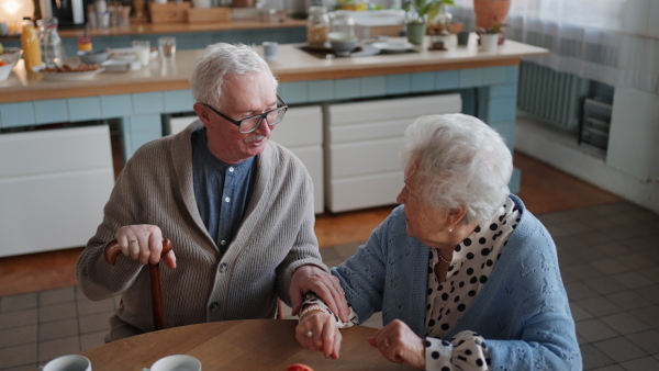 A senior couple enjoying breakfast in nursing home care center.