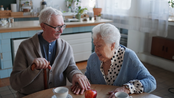 A senior couple enjoying breakfast in nursing home care center.