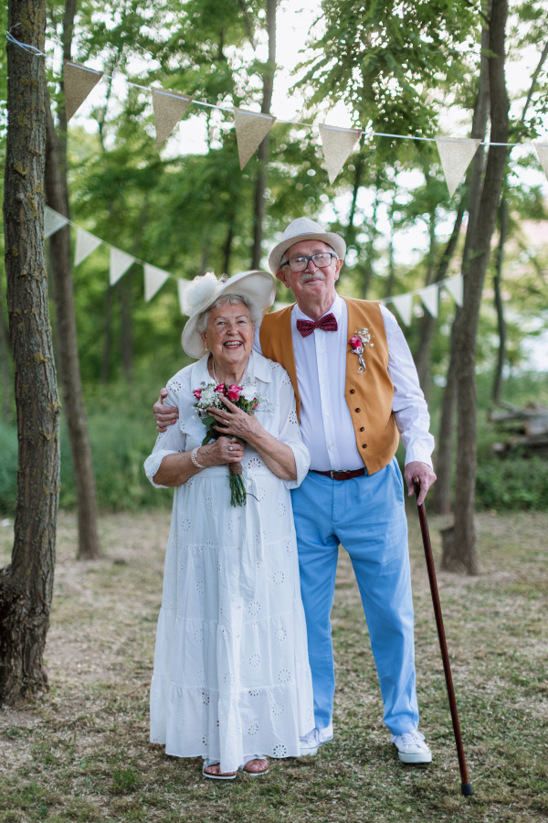 Senior couple having marriage in nature during a summer day.